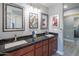 Elegant bathroom with double vanity, granite countertops, and large mirrors at 3731 E Equestrian Trl, Phoenix, AZ 85044