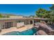 Inviting pool area with a rock waterfall and a spacious patio at 3731 E Equestrian Trl, Phoenix, AZ 85044