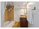 Clean bathroom with tub, shower, granite vanity and brown cabinets at 207 W Clarendon Ave # 20B, Phoenix, AZ 85013
