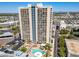 High-rise building with pool and parking, aerial view of the surrounding city at 207 W Clarendon Ave # 20B, Phoenix, AZ 85013