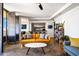 Bright living room with a leather couch, marble-top coffee table, and built-in shelving at 207 W Clarendon Ave # 20B, Phoenix, AZ 85013
