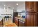 Modern kitchen with granite countertops, dark wood cabinets, and a dining area view at 207 W Clarendon Ave # 20B, Phoenix, AZ 85013