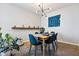 Bright dining room features a wood table with teal chairs and a modern light fixture at 207 W Clarendon Ave # 20B, Phoenix, AZ 85013