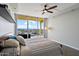 Bedroom with city views, ceiling fan, and striped bedding at 207 W Clarendon Ave # 20B, Phoenix, AZ 85013