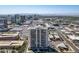 Aerial view of a high-rise building with city views in the background at 207 W Clarendon Ave # 20B, Phoenix, AZ 85013