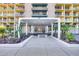 Modern building entrance with landscaping and a bench at 207 W Clarendon Ave # 20B, Phoenix, AZ 85013