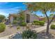 House exterior with mature trees and desert landscaping at 84 S Bolera Ct, Casa Grande, AZ 85194