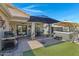 Outdoor patio with hot tub, grill, and seating area at 84 S Bolera Ct, Casa Grande, AZ 85194