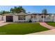 Mid-Century Modern home with a pergola and artificial turf at 8717 E Thornwood Dr, Scottsdale, AZ 85251