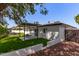 Modern backyard with pergola, artificial turf, and built-in grill at 8717 E Thornwood Dr, Scottsdale, AZ 85251