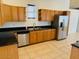 Kitchen with wood cabinets, granite countertops, and stainless steel appliances at 51631 W Turney Ln, Maricopa, AZ 85139