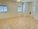 Spacious living room featuring tile flooring and large windows at 51631 W Turney Ln, Maricopa, AZ 85139