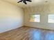 Living room with laminate flooring and large windows at 51631 W Turney Ln, Maricopa, AZ 85139