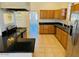 Kitchen with wood cabinets, granite countertops, and stainless steel appliances at 51631 W Turney Ln, Maricopa, AZ 85139