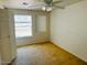 Bright bedroom with carpet, ceiling fan, and large window at 51631 W Turney Ln, Maricopa, AZ 85139