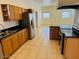 Kitchen boasts wood cabinets, granite counters, and an island at 51631 W Turney Ln, Maricopa, AZ 85139
