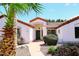 Home entrance with brick walkway, lush landscaping, and a charming door at 18997 N 74Th Dr, Glendale, AZ 85308