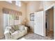 Living room with access to a hallway and large windows at 17235 N White Cloud Cir, Surprise, AZ 85374