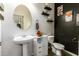 Small bathroom with pedestal sink, toilet, and dark accent wall at 40626 N Laurel Valley Way, Anthem, AZ 85086