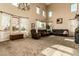 Living room with high ceilings, large windows, and comfortable seating at 40626 N Laurel Valley Way, Anthem, AZ 85086