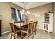 Formal dining room with a large wooden table and seating for six at 40626 N Laurel Valley Way, Anthem, AZ 85086