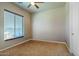 Simple bedroom with large window and ceiling fan at 32120 N 167Th Ave, Surprise, AZ 85387