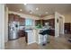 Spacious kitchen with dark wood cabinets, granite counters, and stainless steel appliances at 32120 N 167Th Ave, Surprise, AZ 85387