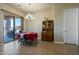 Bright dining area with a red tablecloth, wood hutch, and access to the backyard at 32120 N 167Th Ave, Surprise, AZ 85387