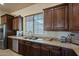 Well-equipped kitchen featuring granite countertops and ample wood cabinetry at 32120 N 167Th Ave, Surprise, AZ 85387