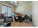 Bedroom with large window and ceiling fan, currently used for storage at 32120 N 167Th Ave, Surprise, AZ 85387
