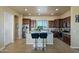 Island kitchen with dark wood cabinets and granite countertops at 32120 N 167Th Ave, Surprise, AZ 85387