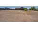 Large empty lot with a house in the background at 32120 N 167Th Ave, Surprise, AZ 85387