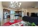Open kitchen features dark wood cabinets, stainless steel appliances, and an island with seating at 32120 N 167Th Ave, Surprise, AZ 85387