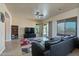 Spacious living room with a large TV and comfortable seating at 32120 N 167Th Ave, Surprise, AZ 85387