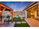 Backyard oasis with pergola, artificial turf and cornhole at 7088 W Redbird Rd, Peoria, AZ 85383