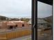 View of backyard from window, showing neighboring homes at 6134 S Borego Rd, Gold Canyon, AZ 85118