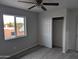 Bright bedroom with large window, ceiling fan, and spacious closet at 6134 S Borego Rd, Gold Canyon, AZ 85118