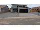 Two-story house with gray exterior, black garage door, and gravel driveway at 6134 S Borego Rd, Gold Canyon, AZ 85118