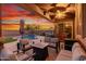 Relaxing backyard oasis with a sparkling pool, patio furniture, and sunset views at 12687 W Caraveo Pl, Peoria, AZ 85383