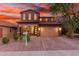 Two-story home with a three-car garage and brick paver driveway at 12687 W Caraveo Pl, Peoria, AZ 85383