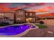 Inviting backyard oasis featuring a sparkling pool, patio furniture, and a built-in barbecue at 12687 W Caraveo Pl, Peoria, AZ 85383