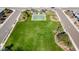 Aerial view of a community park with a basketball court and open green space at 12687 W Caraveo Pl, Peoria, AZ 85383