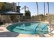 Community pool with a circular design and surrounding patio at 5132 N 31St Way # 114, Phoenix, AZ 85016