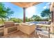 Outdoor kitchen with grill, refrigerator, and stone countertops at 10721 E La Junta Rd, Scottsdale, AZ 85255