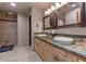 Elegant bathroom with double vanity and a large walk-in shower at 10721 E La Junta Rd, Scottsdale, AZ 85255