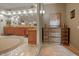 Luxurious Primary bathroom with double vanity and large soaking tub at 10721 E La Junta Rd, Scottsdale, AZ 85255