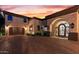 Elegant entryway with ornate iron doors and a welcoming courtyard at 10721 E La Junta Rd, Scottsdale, AZ 85255