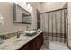 Bathroom with granite countertop, modern sink, and shower at 10721 E La Junta Rd, Scottsdale, AZ 85255