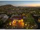 Luxury home with terracotta roof and landscape lighting at sunset at 10721 E La Junta Rd, Scottsdale, AZ 85255