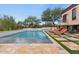 Luxury pool and spa with lounge chairs and stone tile at 10721 E La Junta Rd, Scottsdale, AZ 85255